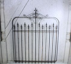 an old iron bed frame with metal bars