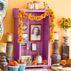 a table topped with plates and bowls filled with food next to pictures on the wall