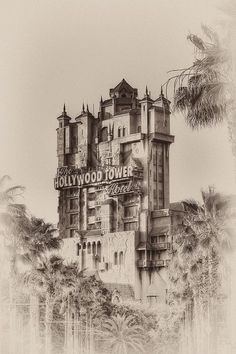 a black and white photo of the hollywood tower hotel in los angeles, with palm trees around it