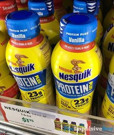 several bottles of protein drink on display in a store