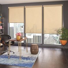 a living room filled with furniture and windows covered in roller shades over the top of them