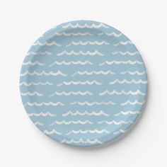 a blue plate with white waves on it