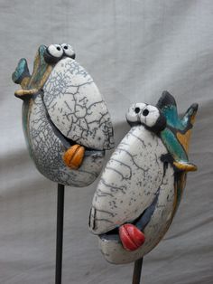 two ceramic birds sitting on top of each other