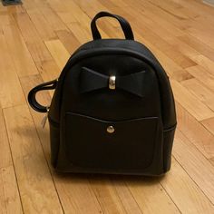 Brand New, Never Opened Or Used. Mini Black Backpack With Bow. Comes With A Small Makeup Bag. Cute Black Backpack With Adjustable Strap, Black Satchel Backpack Cute Style, Cute Black Satchel Backpack, Pink Kanken, Mini Black Backpack, Learning Fashion, Under Armour Backpack, Packable Backpack, Monogram Backpack