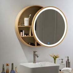 a bathroom sink with a round mirror above it and shelves on the wall behind it