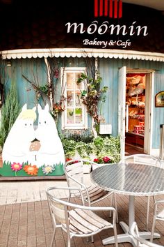 there is a sign that says moomin bakery and cafe in front of the building