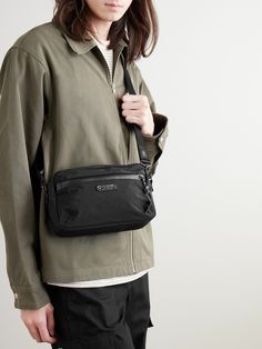 So much thought goes into the materials that make Master-Piece's bags – the front pocket of this 'Root S' messenger, for example, has a water-repellent AquaGuard® zip. Made from hard-wearing nylon with leather trims, it has an adjustable shoulder strap and is sized to hold your phone, keys and wallet. Nylon Shoulder Bag With Pockets For Commuting, Modern Shoulder Bag With Functional Pockets For Everyday, Commuting Crossbody Shoulder Bag With Pockets, Functional Commuting Bags With Multiple Pockets, Nylon Bags With Pockets For Everyday Carry, Nylon Shoulder Bag For Everyday Use, Modern Bags With Multiple Pockets For Commuting, Nylon Bags With Pockets For Everyday, Everyday Nylon Shoulder Bag With Removable Pouch