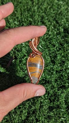 This is one of the most unique materials I have ever worked with. To my knowledge it doesn't have a name but it is from indonesia. My Indonesian distributors call it Timor Agate, Jasper or Plume Agate. To the best of my knowledge it appears similar to an opaque brown crystal infused with smokey gray swirl.  This pendant is wrapped with bare copper square wire. It has not been patinaed and will naturally darken over time to give it an anqitue look.  It will ship with a polishing cloth and a black Artisan Hand Wrapped Pendant Crystal Necklaces, Wire Wrapped Amulet Pendant Crystal Necklace, Wire Wrapped Amulet Crystal Pendant Necklace, Artisan Hand Wrapped Pendant Crystal Necklace, Brown Wire Wrapped Crystal Necklace For Gift, Artisan Wire Wrapped Pendant Crystal Necklaces, Artisan Wire Wrapped Crystal Pendant Necklaces, Artisan Wire Wrapped Crystal Pendant Necklace, Wire Wrapped Crystal Necklace