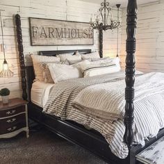 an image of a bedroom with white brick walls and black bed frame on the bottom