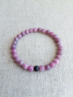 "READY TO SHIP. Lepidolite Gemstone Bracelet*Beaded Bracelets*Stretch Bracelet*Gemstone Jewelry*Gemstone Bracelets for Women*Pink Bracelet*Bead bracelet. Beautiful natural Lepidolite gemstone bracelet will make you look gorgeous. Lepidolite bracelet is the perfect addition to women's or girl's jewelry. Material: Natural Lepidolite gemstone, stretch cord, Matte Black Onyx gemstone Color: Pink Bracelet size: Approx. 16 cm / 6.3\" in (The size could be adjusted upon request) Beads size: Approx. 6 mm / 0.24\" in Please note that color might slightly differ to photography.  For more natural gemstone bracelets, visit my shop: https://www.etsy.com/shop/LemonBracelet Thank you for shopping at LemonBracelet!" Pink Spiritual Gemstone Beaded Bracelets, Spiritual Pink Gemstone Beaded Bracelets, Pink Gemstone Beads Bracelets For Meditation, Pink Gemstone Beaded Bracelets For Healing, Pink Stretch Bracelet With Natural Stones For Meditation, Pink Natural Stones Stretch Bracelet For Meditation, Lepidolite Bracelet, Pink Beaded Bracelets, Bracelet Bead