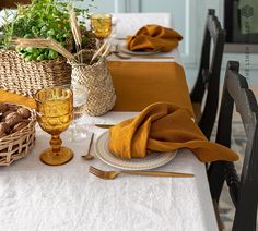 the table is set with dishes and place settings