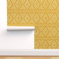 a yellow wallpaper with white geometric designs on it