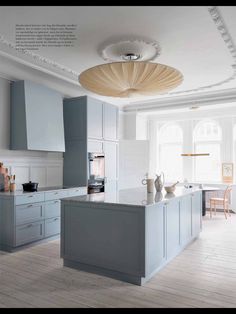 a white and grey kitchen with wooden floors