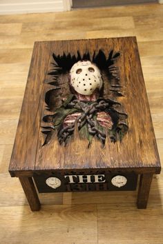 a wooden table topped with a hockey mask on top of it