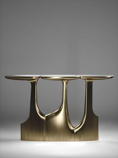 two tables with gold colored metal bases