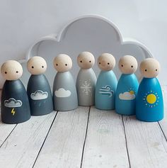 a group of wooden peg dolls sitting next to each other