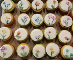 there are many cupcakes with flowers painted on them