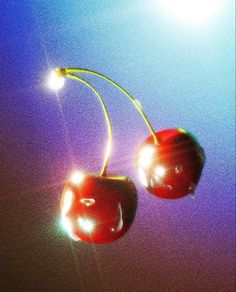 two cherries hanging from a yellow wire on a purple and blue background with the sun behind them