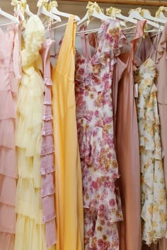 several dresses are hanging on a clothes rack