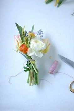 a bouquet of flowers sitting next to a pair of scissors