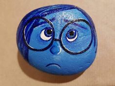 a close up of a blue ball with glasses on it's face and eyes