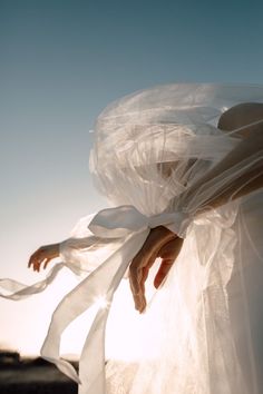 a person wearing a white dress with sheer fabric