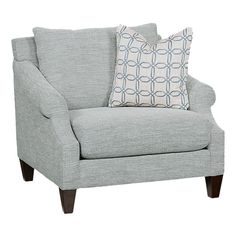 a gray chair with two pillows on it and a pillow in front of the chair