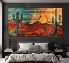 a large painting hanging on the wall above a bed