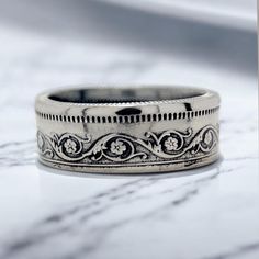 🌟 **Celebrate the Rich Heritage of Pakistan with Our Unique Coin Ring 🌟 Discover the vibrant culture and deep history of Pakistan with this beautifully crafted Coin Ring, made from an authentic Pakistani coin. Pakistan, a land of stunning contrasts, is home to breathtaking mountain ranges, including the Karakoram and the Himalayas, ancient Indus Valley civilizations, and iconic Mughal architecture like the Lahore Fort and Shalimar Gardens.  This exquisite ring, designed from a genuine Pakistani coin, embodies the spirit of a nation that blends tradition and modernity. The coin itself reflects Pakistan's journey, marked by symbols of unity, resilience, and cultural diversity. From the bustling markets of Karachi to the serene valleys of Hunza, Pakistan's heart beats with life, history, an Heirloom Band Jewelry As Gift, Heirloom Band Jewelry Gift, Unique Jewelry With Decorative Band As Gift, Unique Jewelry With Decorative Band For Gift, White Gold Rings With Decorative Band As Gift, Decorative Band Engraved Ring As Gift, Unique Decorative Band Jewelry Gift, Stackable Band Rings As Gift, Adjustable Stackable Band Rings For Gift