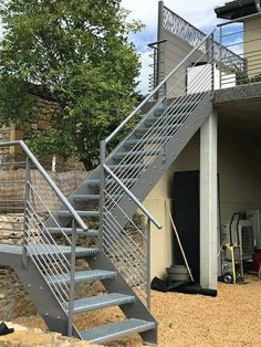 a set of stairs leading up to the top of a building with metal railings