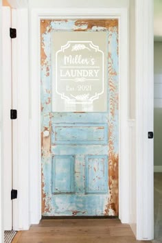 an old blue door with the word laundry painted on it