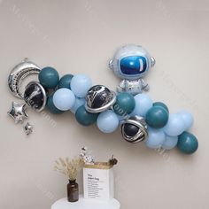 balloon decorations are arranged in the shape of an astronaut's helmet and other items