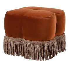 a large brown ottoman with tassels on it