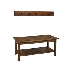 a coffee table and coat rack with hooks on the wall