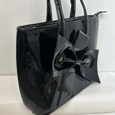 J. Francis Black Patent Leather Tote/Travel Bag With Large Bow On Front Like New Condition Zipper Across The Top, Inside I S Very Clean Never Used, With One Open Pocket And One Zipper Pocket. Photo 7 Small Smudge On Back Near Handle. Gold Tone Hardware. (J) 17.5in. W And 11in. (E) Pocket Photo, Vacation Bag, Carry On Suitcase, Travel Duffel, Duffel Bag Travel, Large Bow, Travel Tote, Cosmetic Pouch, Garment Bags