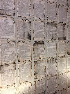 many old books are stacked on top of each other with holes in the middle to show them