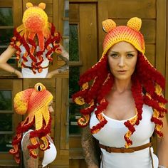 a woman wearing a red and yellow crocheted hat with fish decorations on it