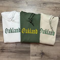 Show off your team pride with our Oakland A's fully embroidered hoodie! Crafted from premium, soft fabric, this hoodie combines comfort and style, making it perfect for game days or everyday wear. The intricate embroidery showcases the iconic A's logo, ensuring you stand out in the crowd. Available in a variety of colors and sizes, this hoodie caters to every fan's preference. Whether you're cheering from the stands or hanging out with friends, you'll stay warm and stylish. With a cozy fit and durable design, this hoodie is a must-have for any Oakland A's supporter. Gear up and represent your team in comfort! I also offer this design on both hoodies and t-shirts. Check out my page to purchase. Message for any questions! Baseball Sweatshirts, Sweatshirt Vintage, Baseball Fan, Intricate Embroidery, Cozy Fits, Embroidered Hoodie, World Series, Stay Warm, Hanging Out