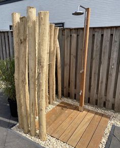 a wooden bench sitting in the middle of a yard next to a tree stump fence