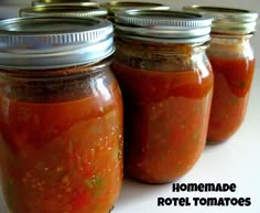 three jars filled with hot sauce sitting on top of a table