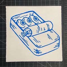 a drawing of a book with two eyes and a rolled up book in the middle