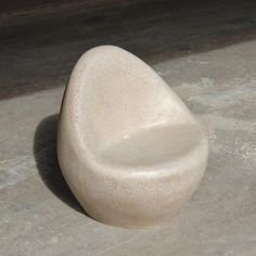 a white rock sitting on top of a cement floor