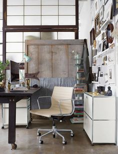 an office area with a desk, chair and bookshelf