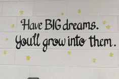 a white wall with black writing on it that says, have big dreams you'll grow into them