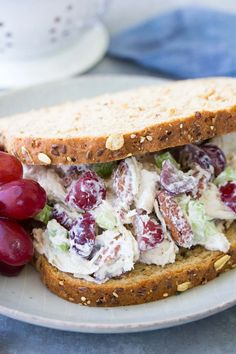 a sandwich with grapes and chicken salad on it