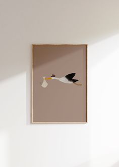 a stork with a baby in it's beak hanging on the wall