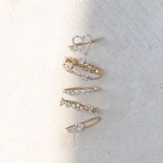 three gold hair pins with diamonds on them