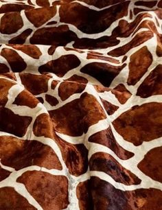 a giraffe print fabric that is brown and white