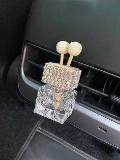 the interior of a car with two crystal cubes on it's center console