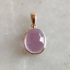 DESCRIPTION: This stunning Pendant is set in 14k Solid Yellow Gold with Natural Kunzite with utmost precision. It is a unique gemstone Pendant for nearly every occasion and is completely hassle-free jewelry. ITEM DETAILS: * GEM : Kunzite * GEM SIZE: 9X11mm * GEM SHAPE: Oval * Gem weight: 7.30 carats * Gold Purity: 14KT (58.33% approx.) * Gold Weight: 0.54gram * Total Weight of the Pendant: 2.00 gram The Gold purity is guaranteed and it comes with authentic 14KT gold hallmark. Since my items are handmade, they are absolutely nickel and lead free. CUSTOMIZATION: * Gemstone customization is available and it can be substituted with a gem of your choice. Kindly message me for the same. PACKAGING * The Pendant comes with layers of safe and secure wrapping along with Free handmade jewelry box wit Luxury Gold Oval Cabochon Gemstones, Luxury Gold Oval Gemstones, Classic Oval Bezel Set Gemstones, Classic Oval Gemstone With Bezel Setting, Gold Cabochon Gemstones For Formal Occasions, Formal Gold Cabochon Gemstones, Gold Round Gemstones With Polished Finish, Round Gold Gemstones With Polished Finish, Yellow Gold Polished Oval Cabochon Gemstones